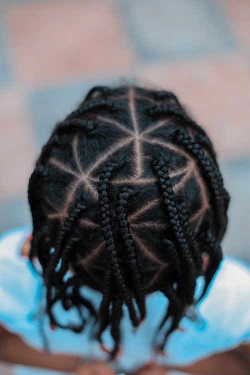 African hair braider's client showing off new look