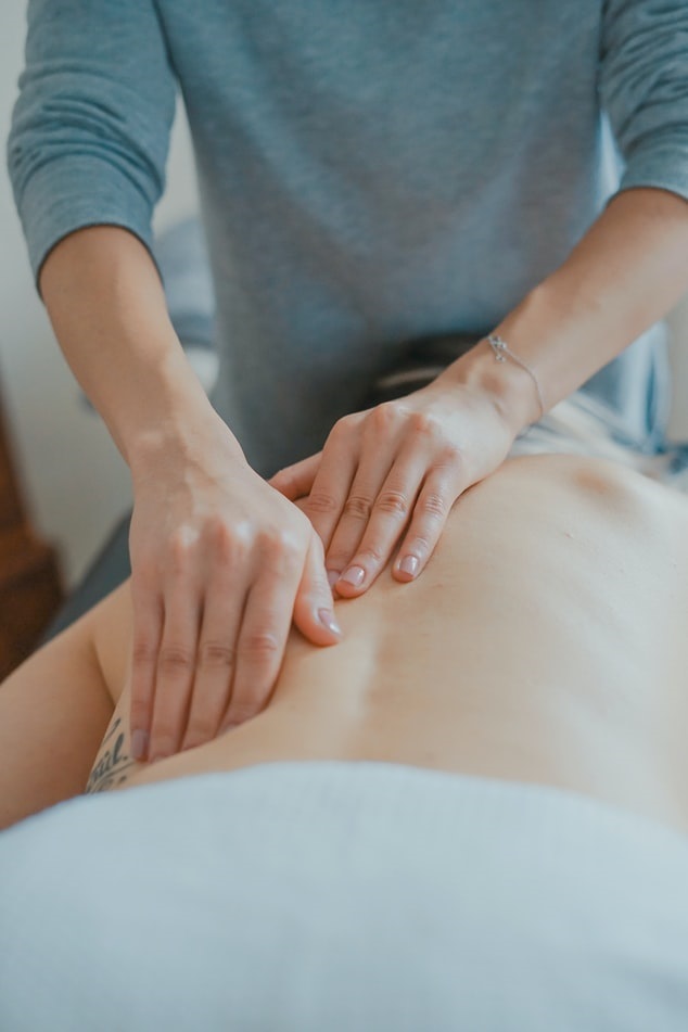 Massage therapist massaging a client's back