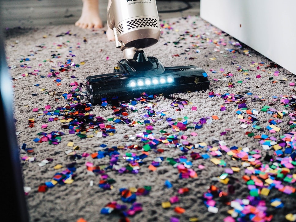 Carpet cleaner vacuuming confetti