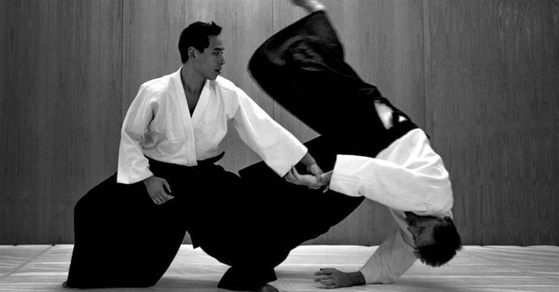 Aikido instructor demonstrating a takedown move