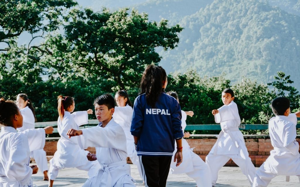 Taekwondo instructor teaching a class of young students