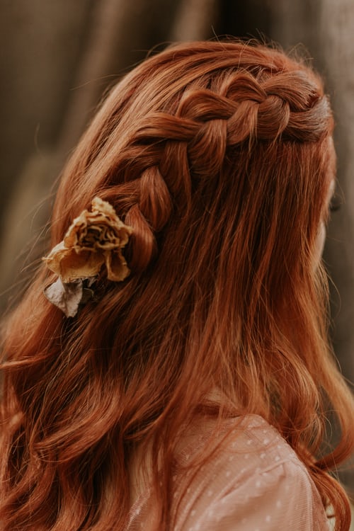 Woman with braided hair and flower in hair