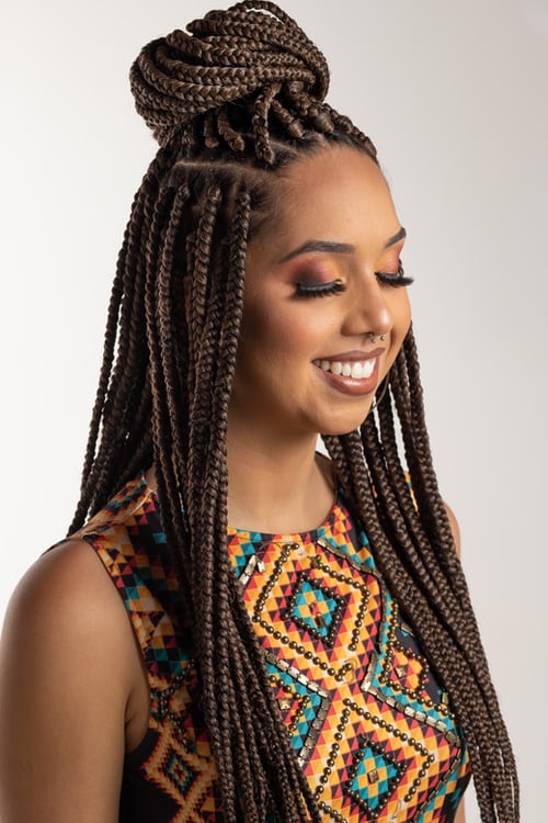 African hair braider's client modeling work