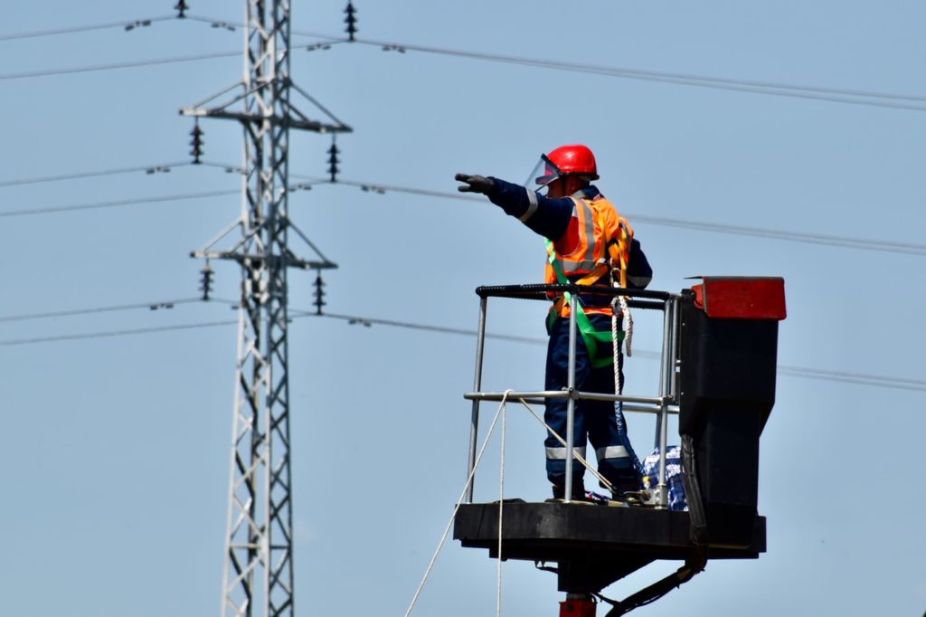 Wireman electrician communicating on a worksite outdoors