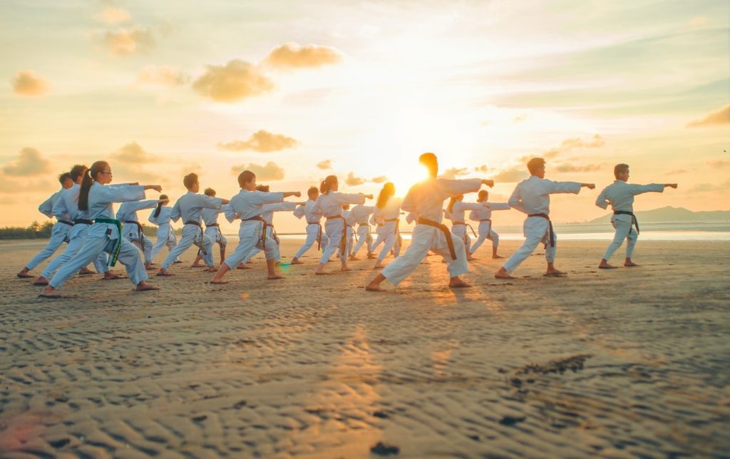 Karate class taking place on a beach