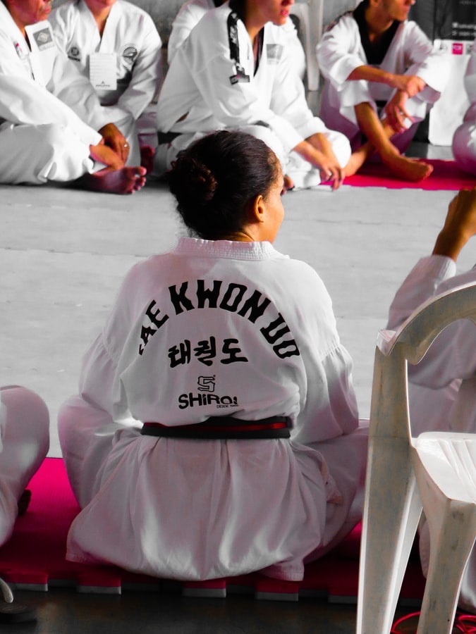Taekwondo student sitting in a class