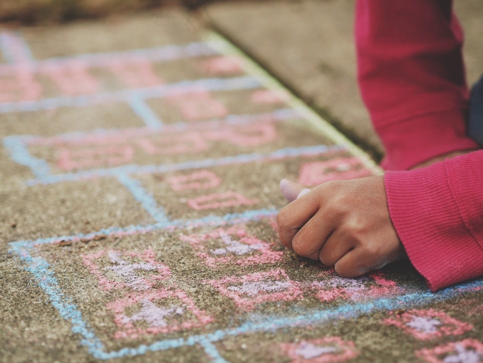 Child using chalk on carpet