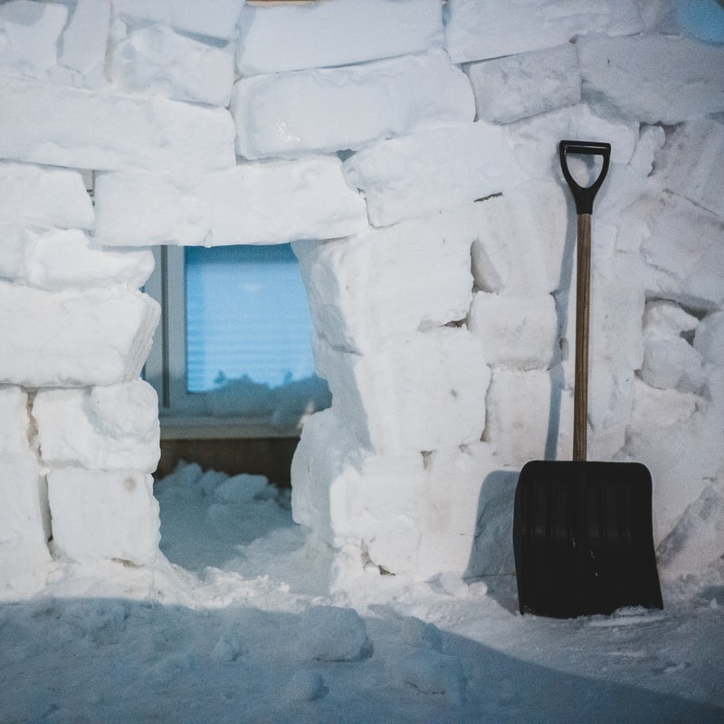 Shovel leaning up against a wall of snow