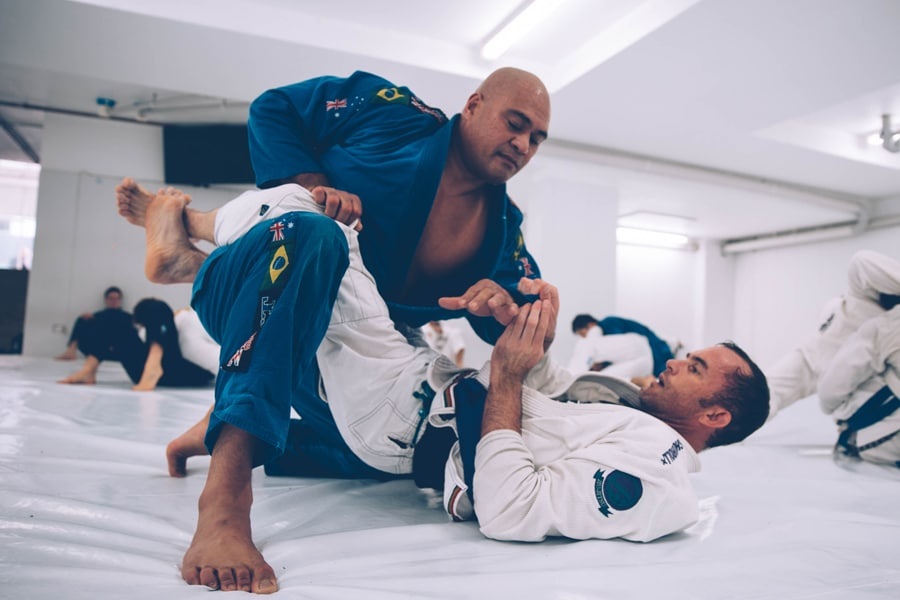 Jiu Jitsu fighters training in a class with other partners