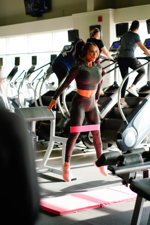 Woman working out in gym using a resistance band