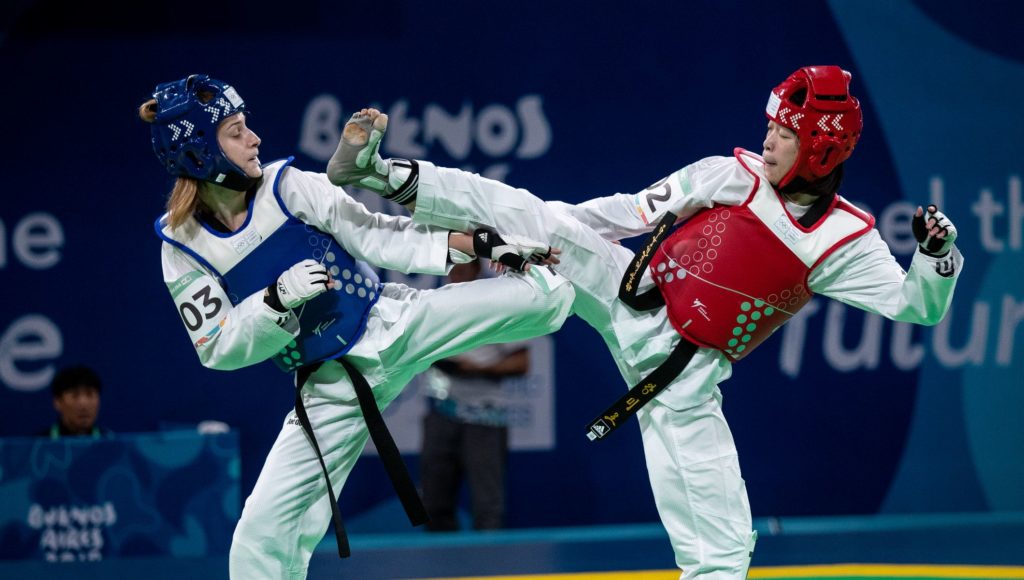 Taekwondo competitors fighting in a match