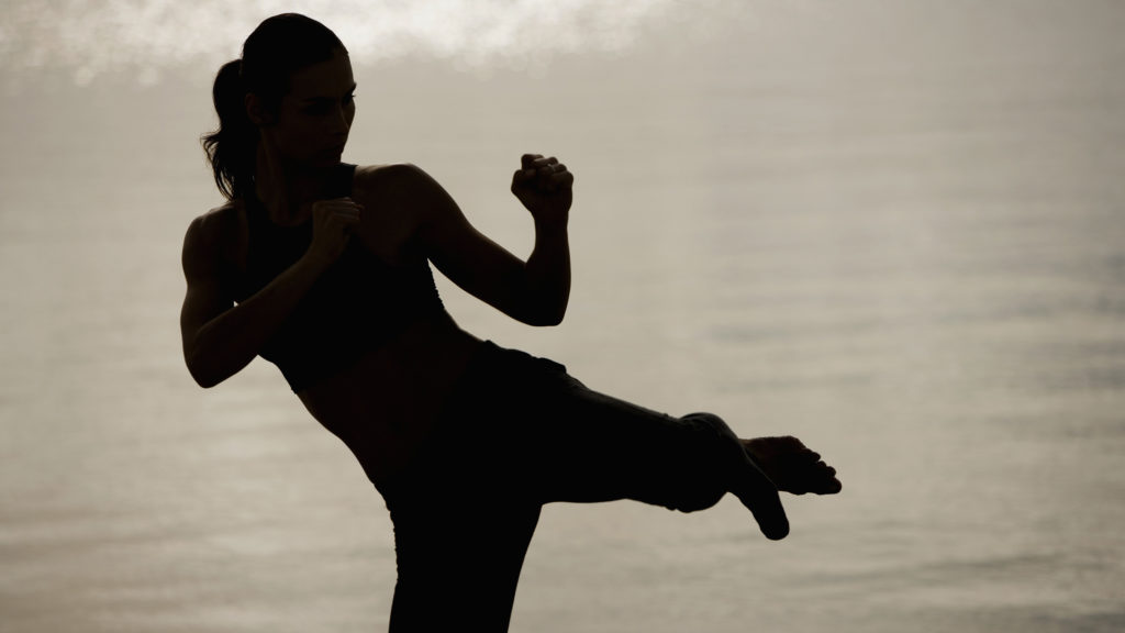 Silhouette of self defense instructor with the ocean in the background