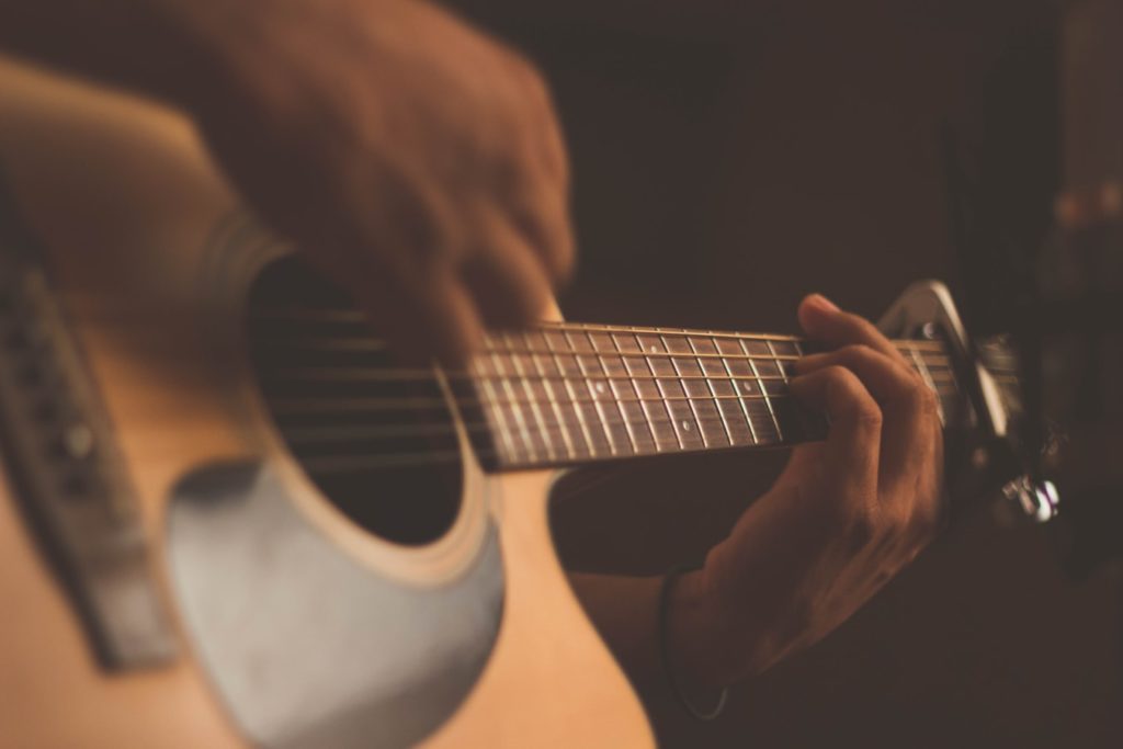 Close up of a music instructor's hands playing a guitar