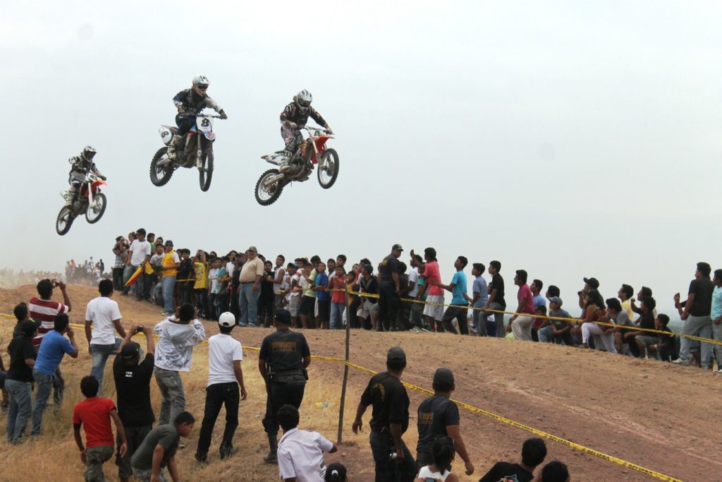 Motocross racers in mid-air on a race track