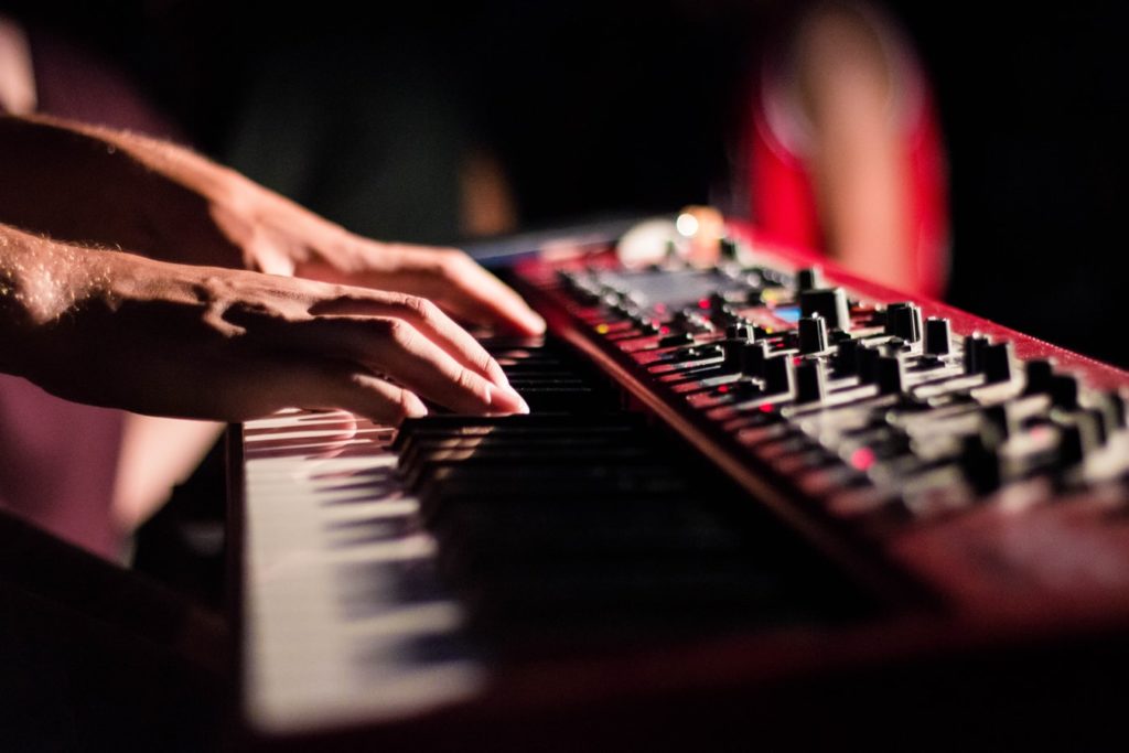 Close up of a music instructor's hands playing a keyboard