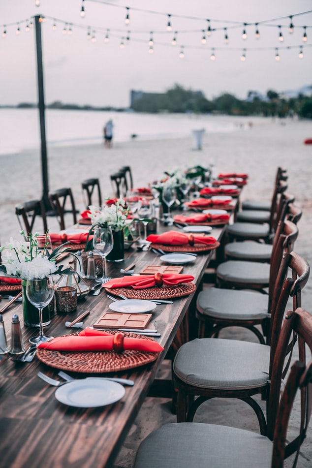 Fully set table prepared for an event on a beach