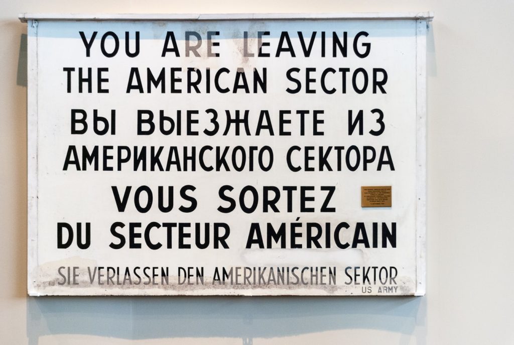 A sign with an English phrase translated in several different languages