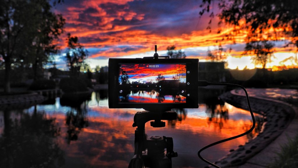 View of a landscape photographer's monitor showing the sunset that it is capturing