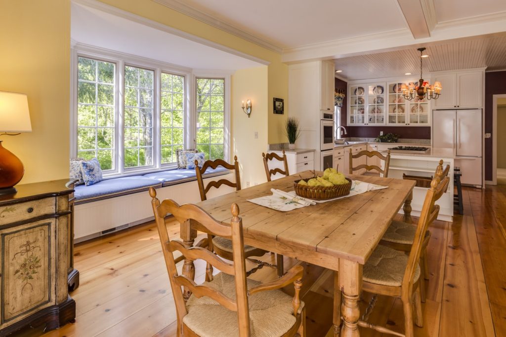 Staged photo of a rustic dining room and kitchen space